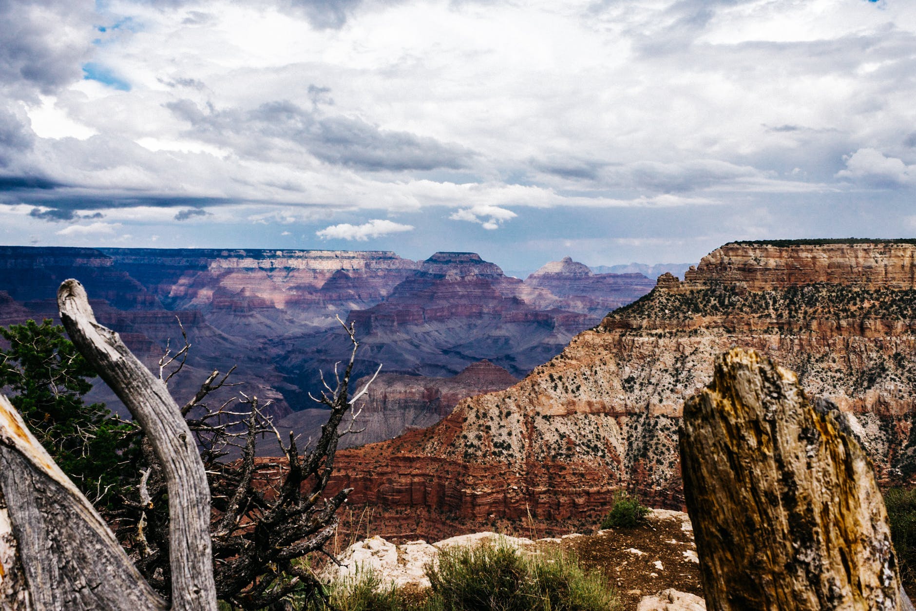 brown rock formation under white clouds